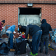 Residents help with the cleanup at a CVS that was looted on April 27.